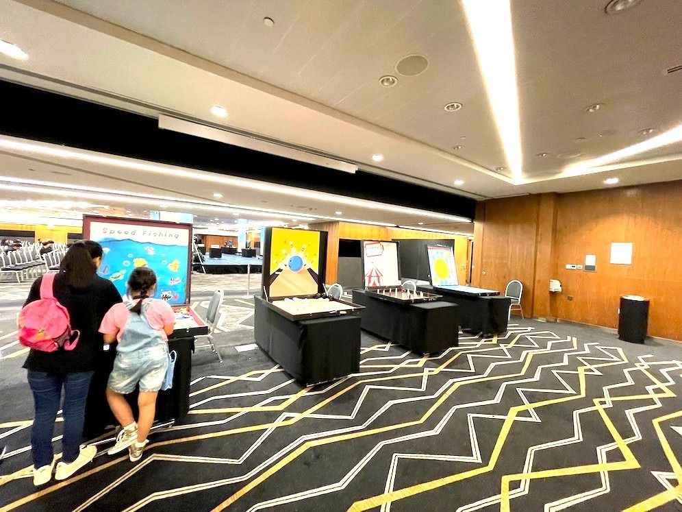 Speed fishing carnival game booth at an indoor corporate event in Singapore