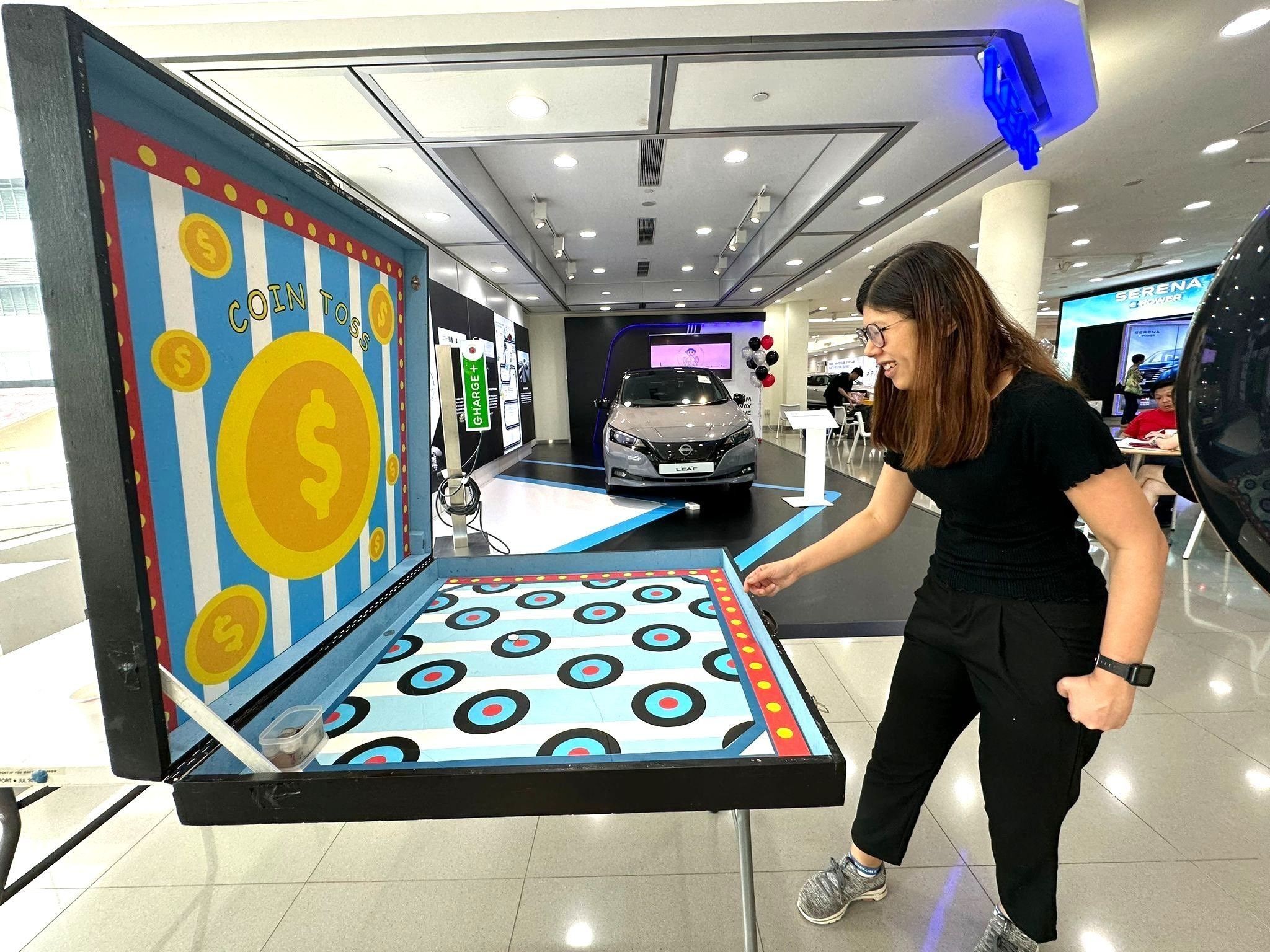 Coin toss carnival game rental at a car showroom event in Singapore