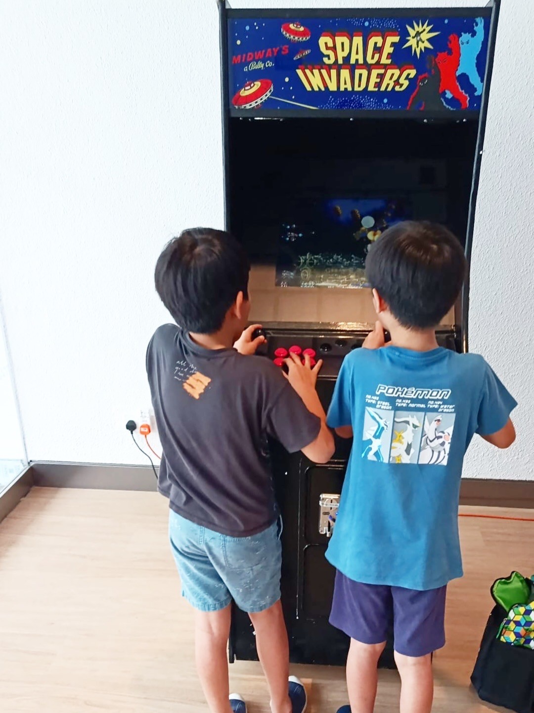 Kids playing retro Space Invaders arcade machine rental in Singapore