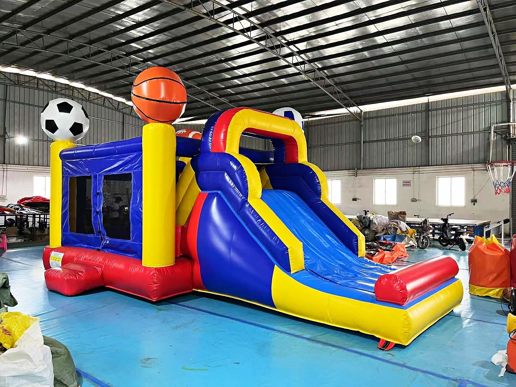 Bouncy Castle Rental: 6 Smart Ways to Choose for Your Event 7 Sports themed bouncy castle with a blue and yellow slide