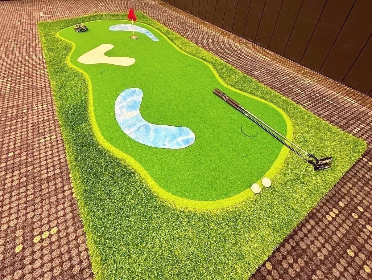 Carnival Games Singapore: A Family-Day Stamp Card Plan 6 Mini-golf putting green with flags, golf balls and putters at an indoor event