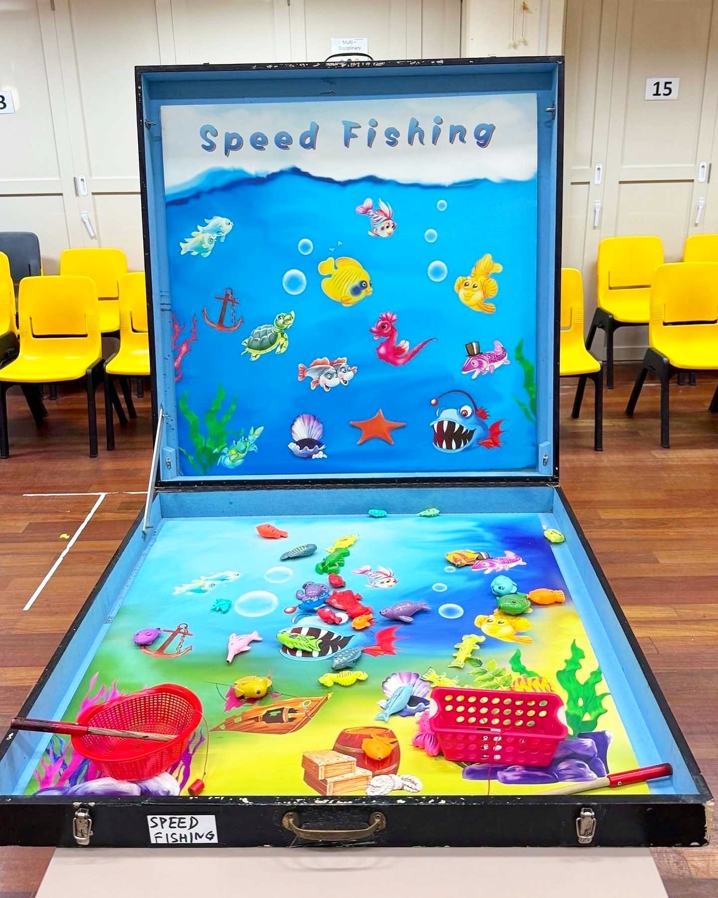 Carnival Games Singapore: A Family-Day Stamp Card Plan 12 Speed Fishing carnival game with toy fish, fishing rods and a blue display board