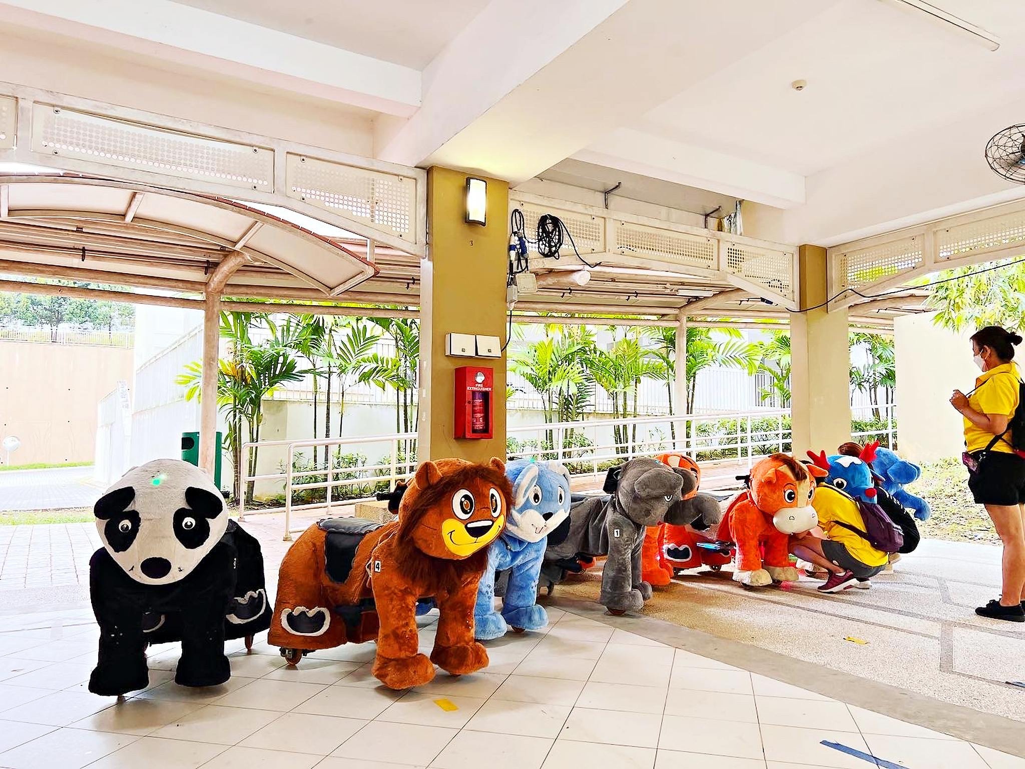 Carnival Rides for a Family Day: Trains, Animal Rides and Go-Karts 13 Plush animal rides lined up in a covered event area