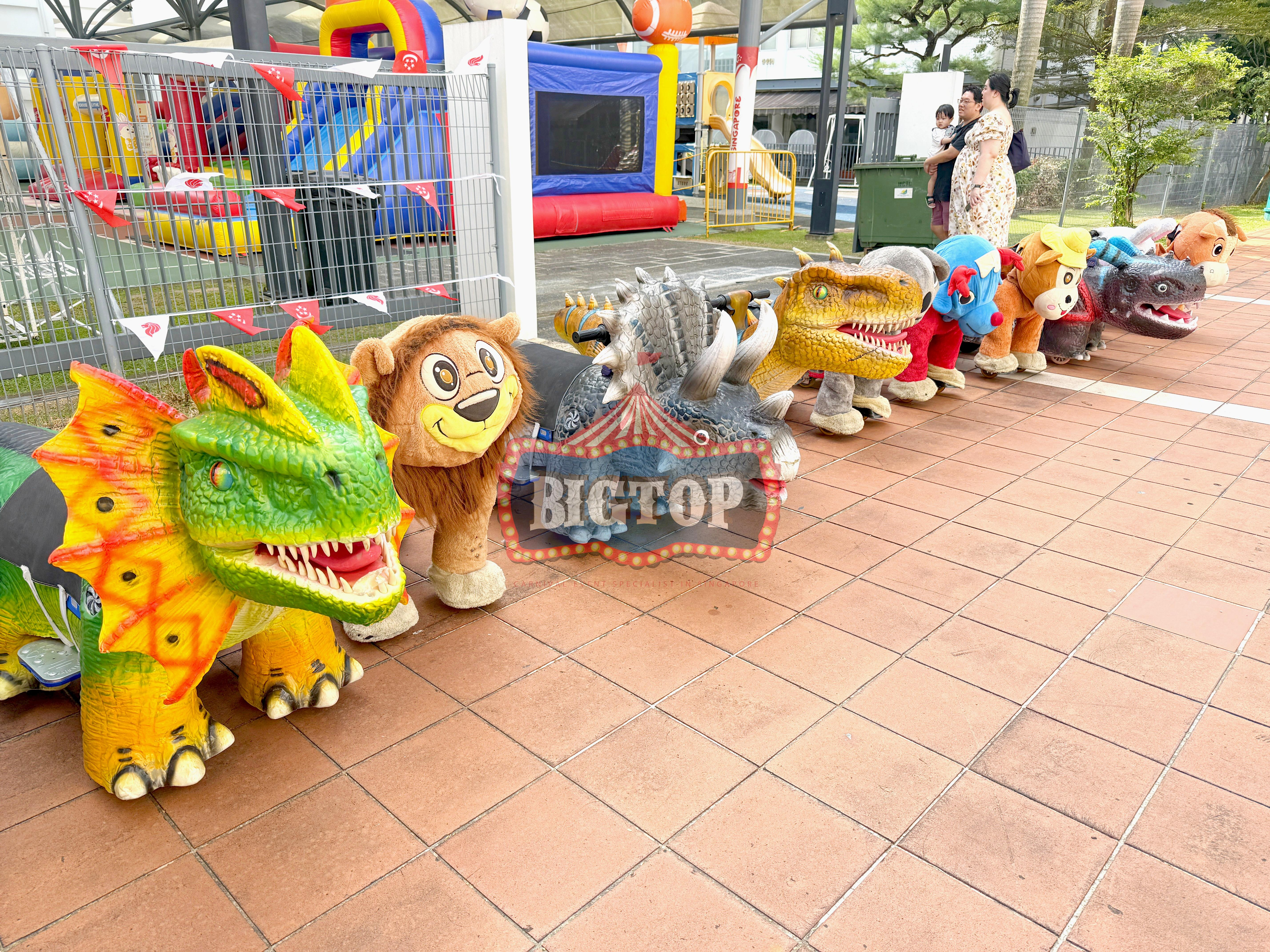 Carnival Rides for a Family Day: Trains, Animal Rides and Go-Karts 11 Animal rides arranged along an outdoor event walkway