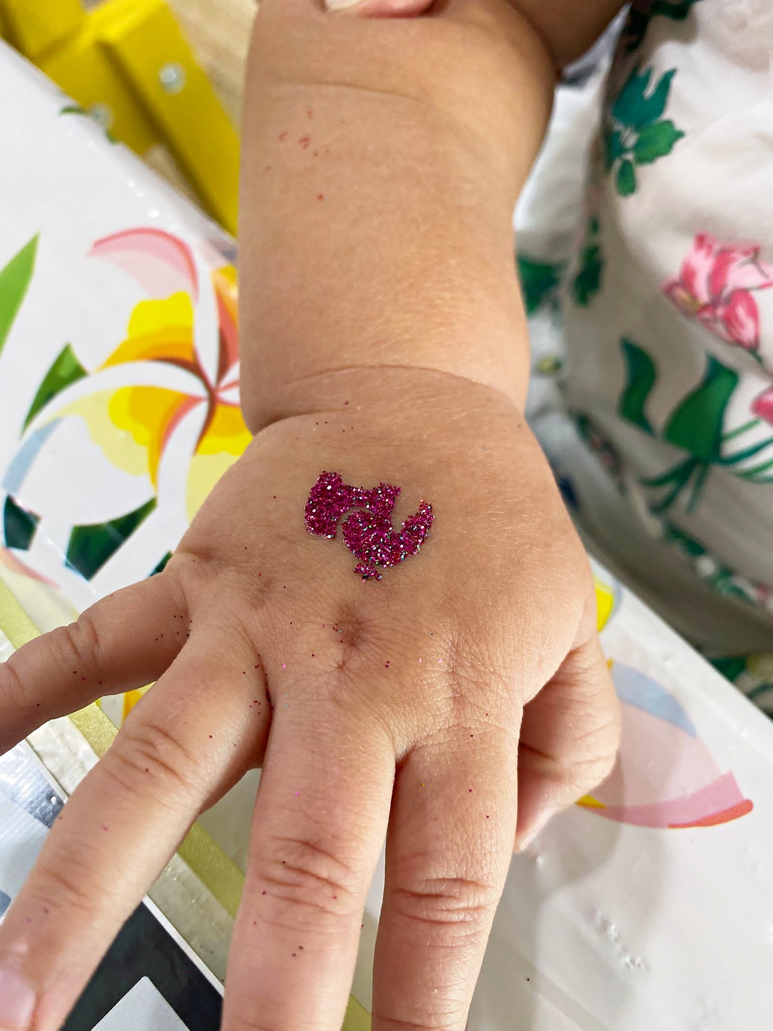 Creative Fringe Activities: 6 Smart Ways to Plan a Personalised Event 9 Bird glitter tattoo on a guest's hand