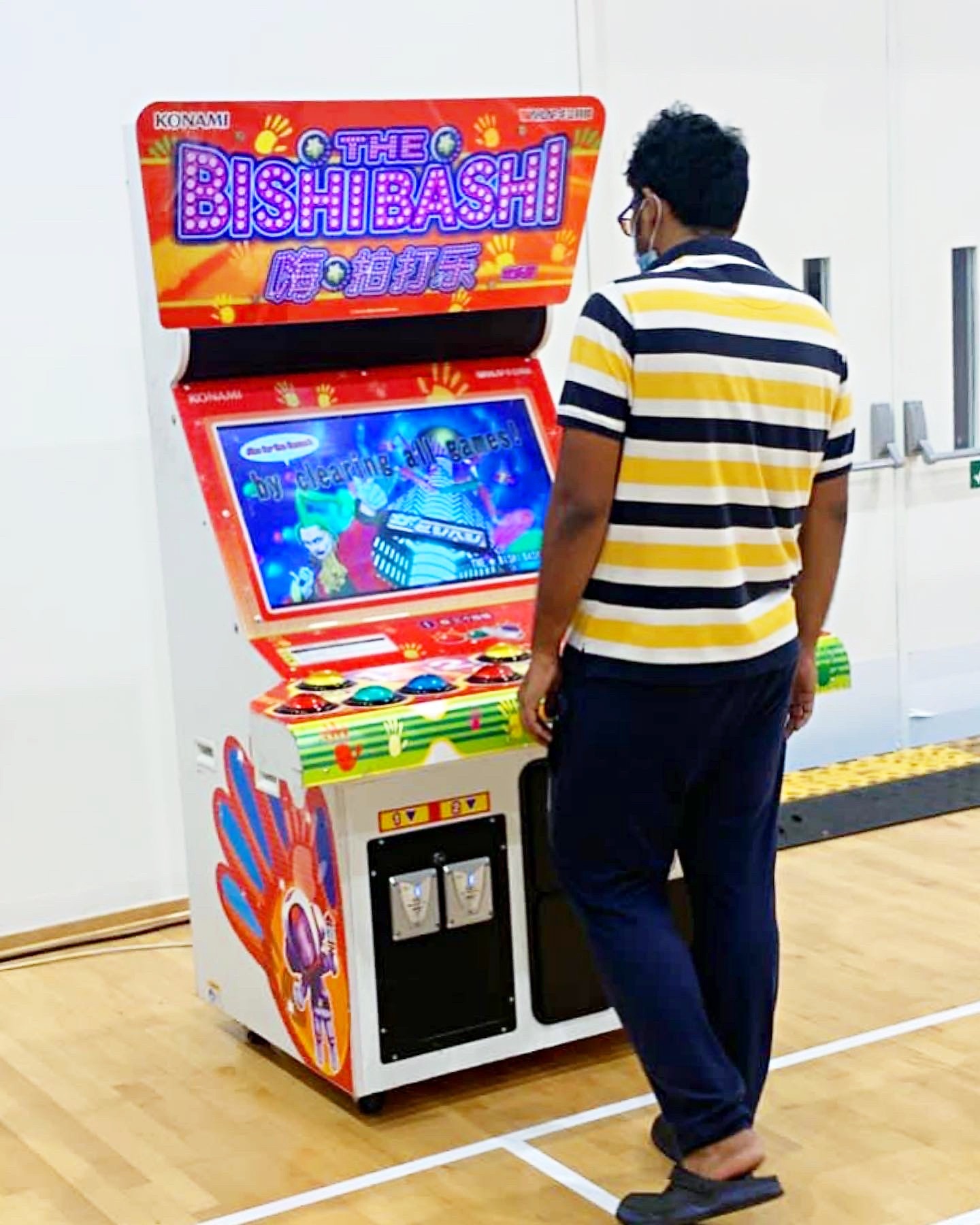 Arcade Party Ideas: From a Neon Games Room to a Racing Lounge 12 Guest playing a Bishi Bashi arcade cabinet