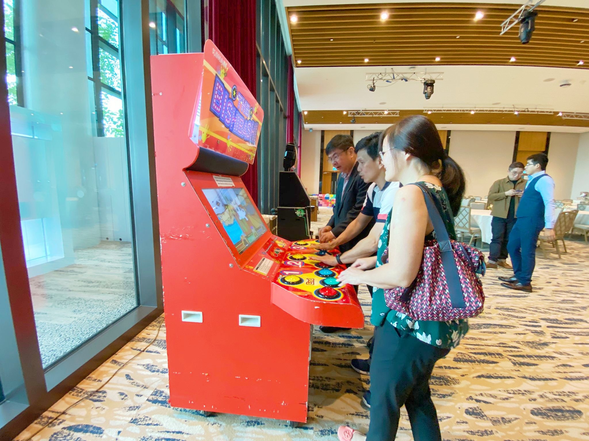 Arcade Party Ideas: From a Neon Games Room to a Racing Lounge 5 Guests playing a multiplayer Bishi Bashi arcade game
