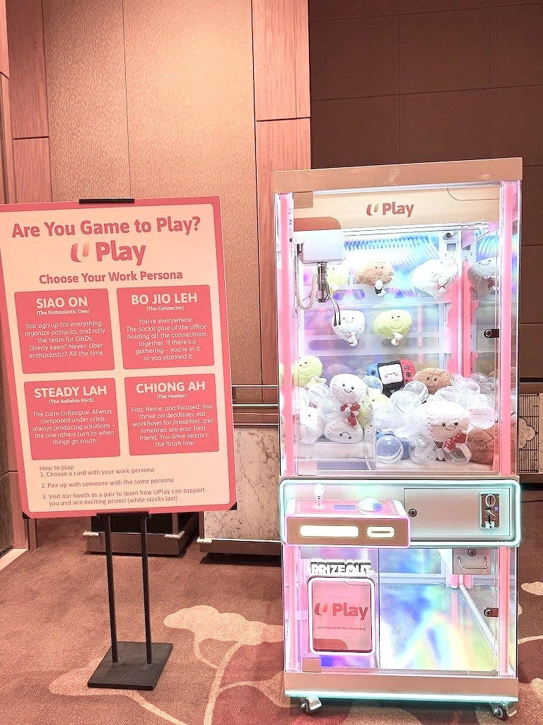 Arcade Party Ideas: From a Neon Games Room to a Racing Lounge 11 Pink claw machine filled with plush prizes at a branded event