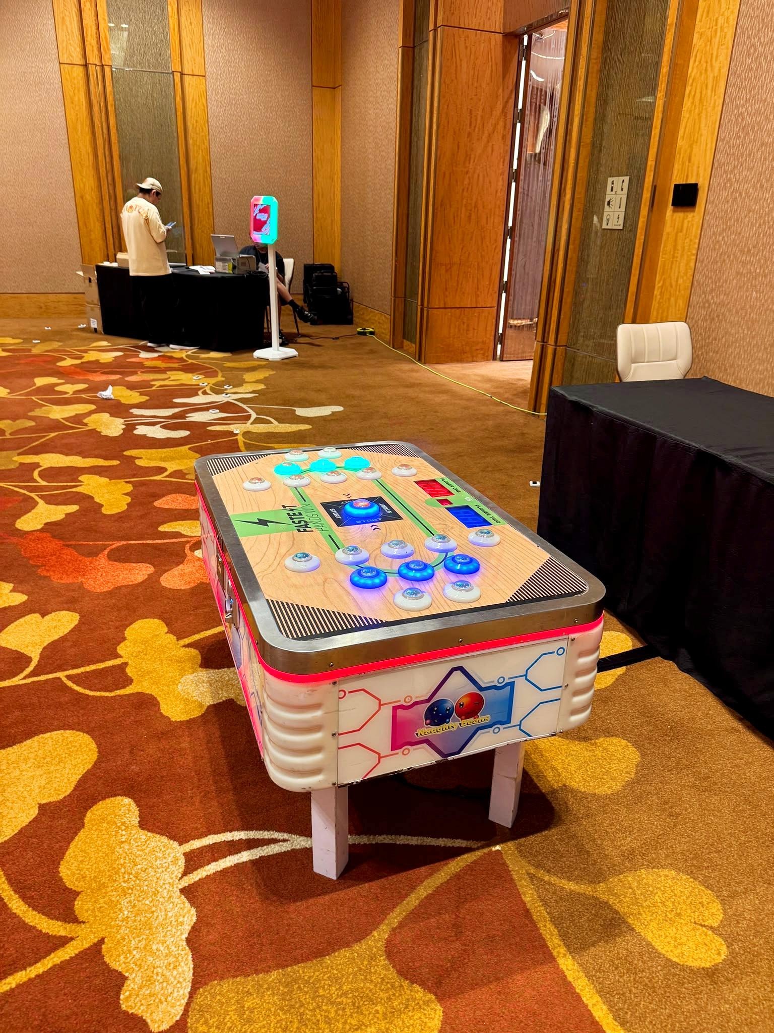 Arcade Party Ideas: From a Neon Games Room to a Racing Lounge 8 Compact tabletop arcade game in a hotel function area