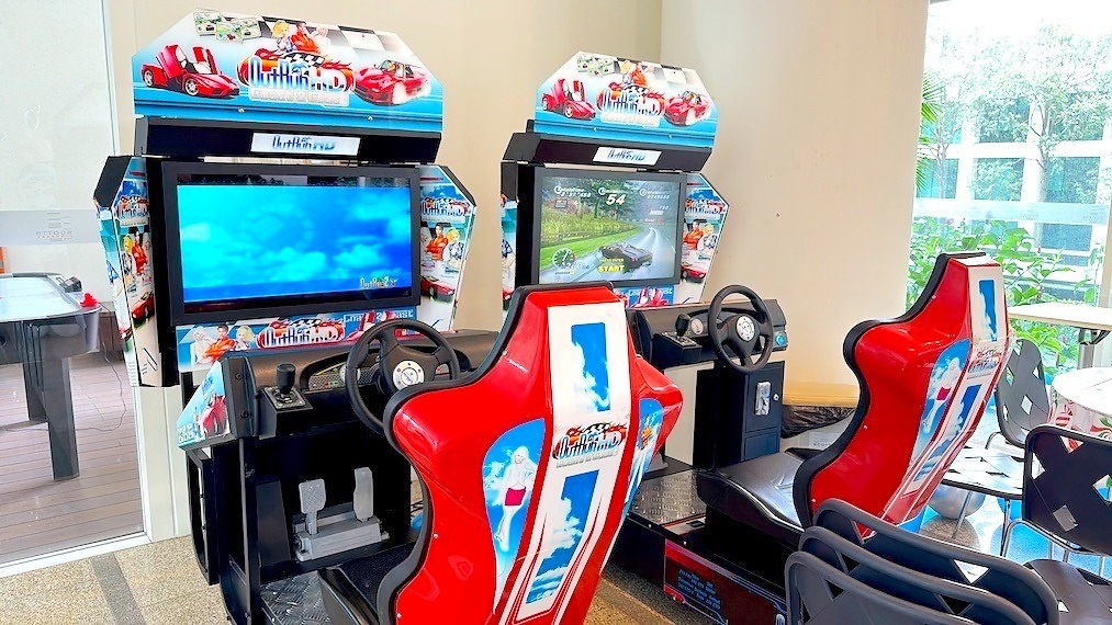 Arcade Party Ideas: From a Neon Games Room to a Racing Lounge 3 Twin racing arcade machines with steering wheels and red seats