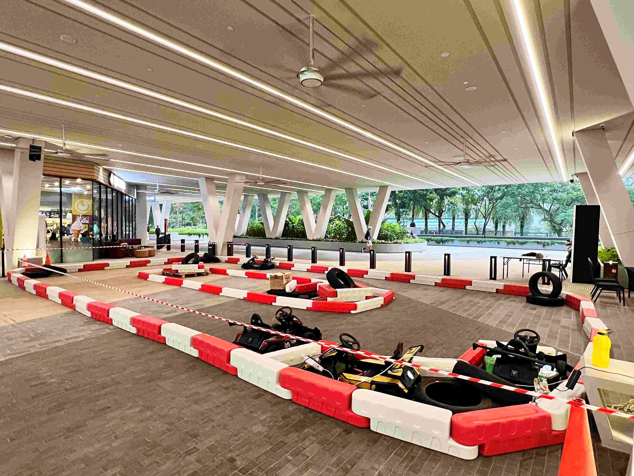 Carnival Rides for a Family Day: Trains, Animal Rides and Go-Karts 4 Go-kart circuit with red and white barriers in a sheltered venue