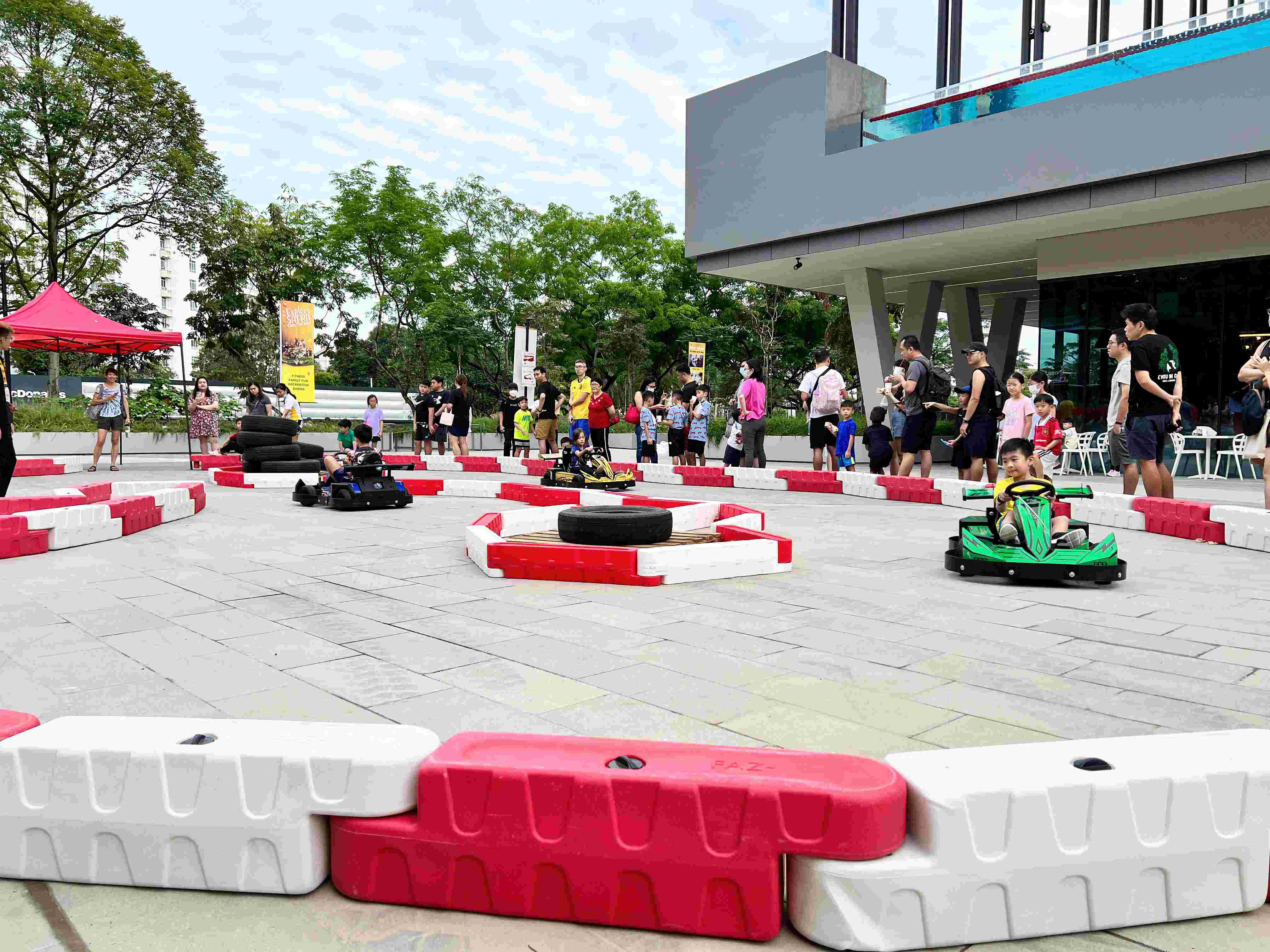 Carnival Rides for a Family Day: Trains, Animal Rides and Go-Karts 9 Outdoor go-kart event with spectators beside the circuit